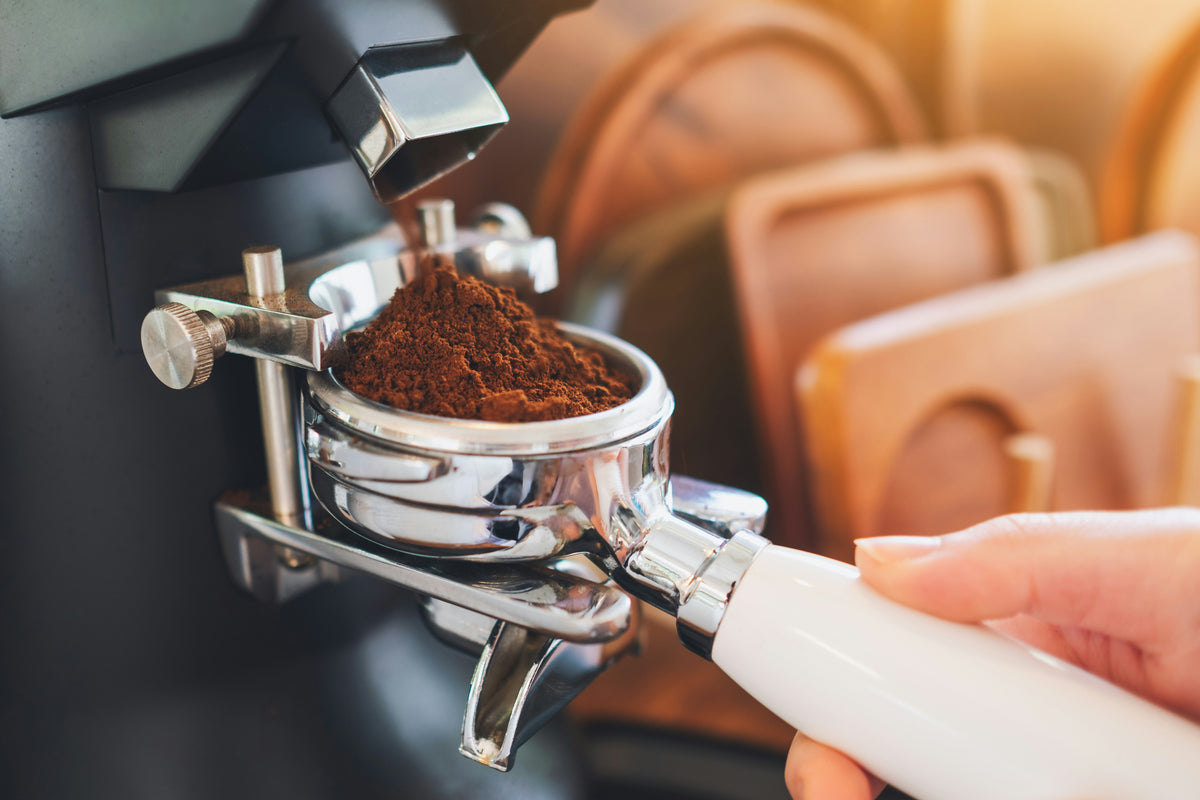 Dosing ground coffee into portafilter